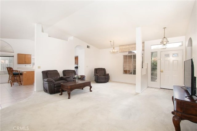 2869 Maple Dr, Hemet, CA 92545 - living area featuring arched walkways, light colored carpet, a chandelier, and lofted ceiling