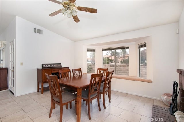 2869 Maple Dr, Hemet, CA 92545 - dining space with vaulted ceiling, baseboards, a ceiling fan, and light tile patterned floors