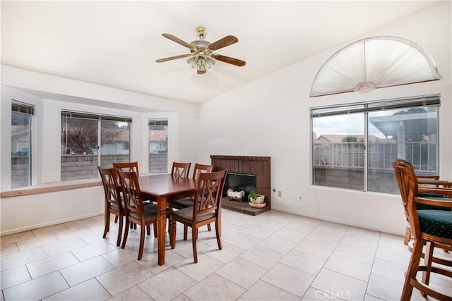 2869 Maple Dr, Hemet, CA 92545 - dining room featuring lofted ceiling, ceiling fan, light tile patterned floors, baseboards, and a fireplace