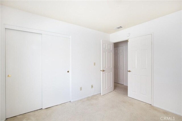 2869 Maple Dr, Hemet, CA 92545 - unfurnished bedroom with light colored carpet, a closet, and baseboards