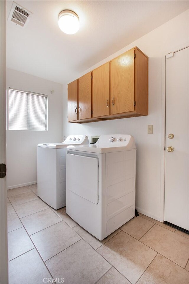 2869 Maple Dr, Hemet, CA 92545 - clothes washing area featuring cabinet space, washer and clothes dryer, baseboards, and light tile patterned flooring
