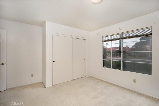 2869 Maple Dr, Hemet, CA 92545 - unfurnished bedroom with light carpet, a closet, and baseboards