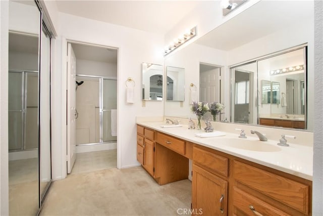 2869 Maple Dr, Hemet, CA 92545 - bathroom featuring a shower stall, double vanity, and baseboards