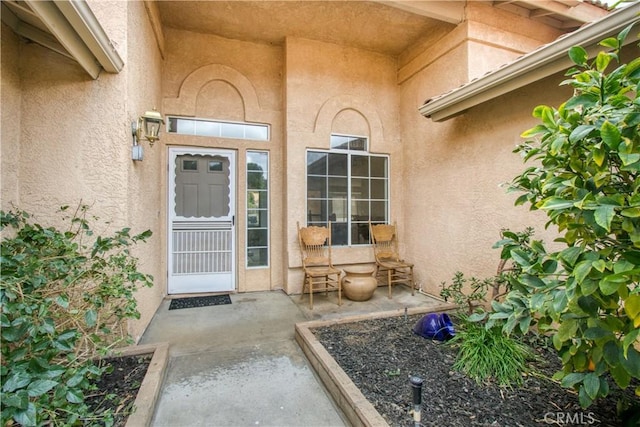 property entrance featuring a patio area