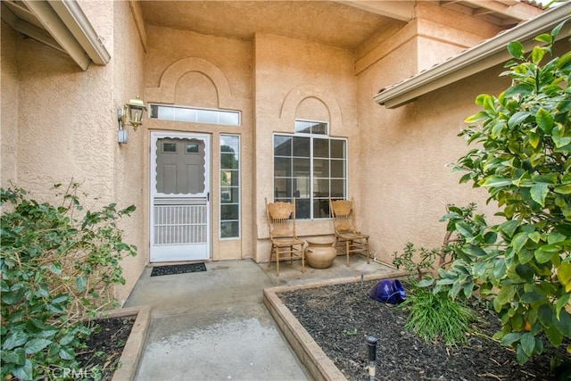 2869 Maple Dr, Hemet, CA 92545 - view of exterior entry featuring stucco siding and a patio