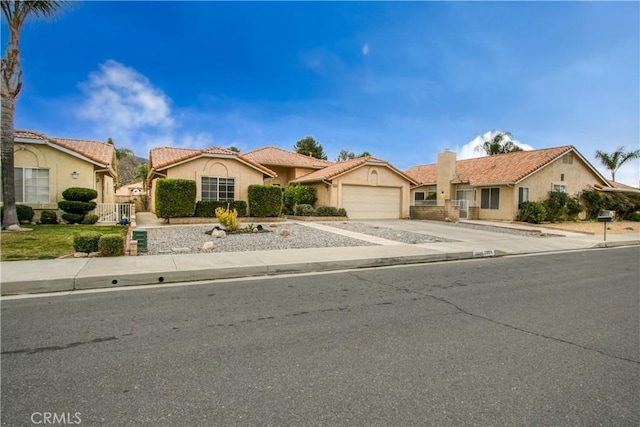 2869 Maple Dr, Hemet, CA 92545 - view of front facade featuring a garage, stucco siding, driveway, a tile roof, and fence