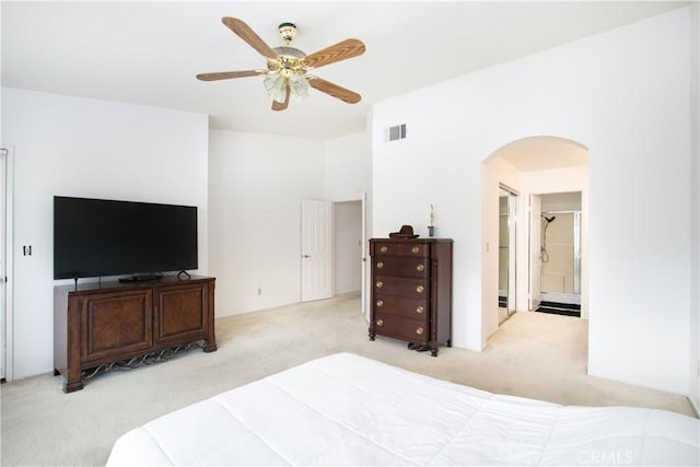 2869 Maple Dr, Hemet, CA 92545 - bedroom with carpet floors, arched walkways, ceiling fan, and ensuite bathroom