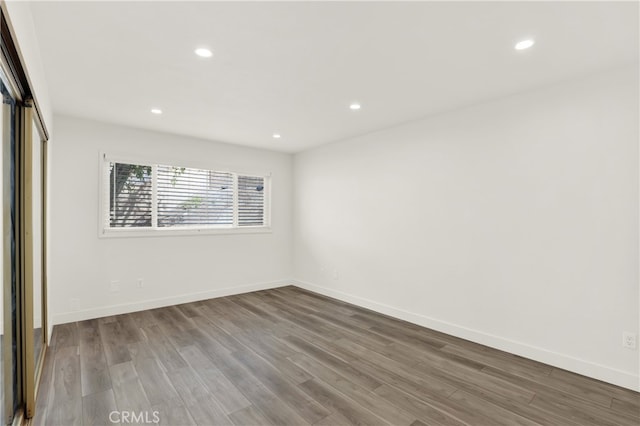 spare room with hardwood / wood-style flooring