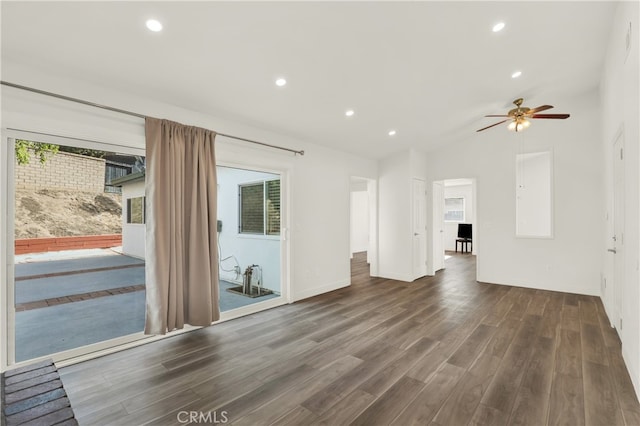 unfurnished living room with lofted ceiling, dark hardwood / wood-style floors, and ceiling fan