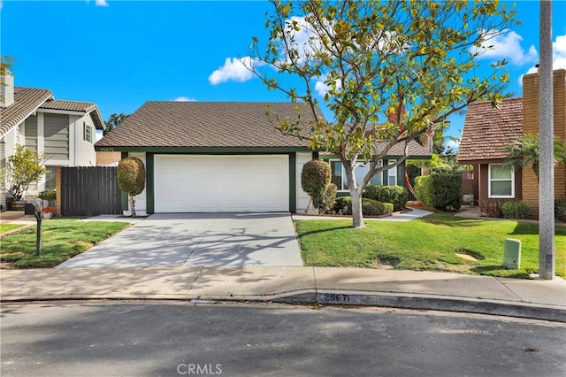 view of front of home featuring a garage and a front lawn