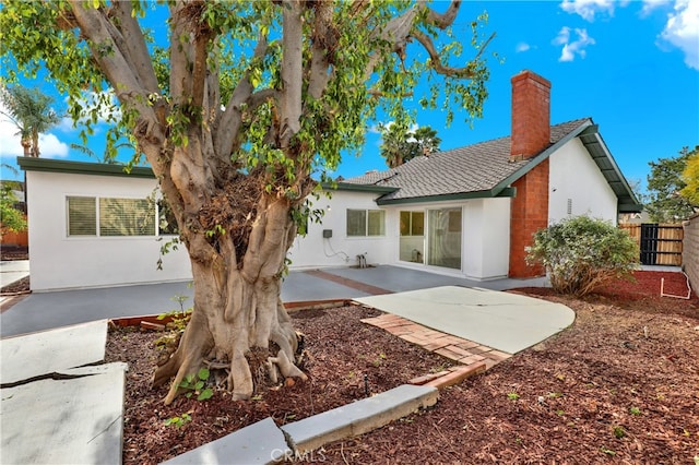 rear view of property featuring a patio area