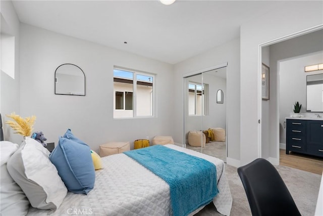 bedroom featuring light colored carpet and a closet