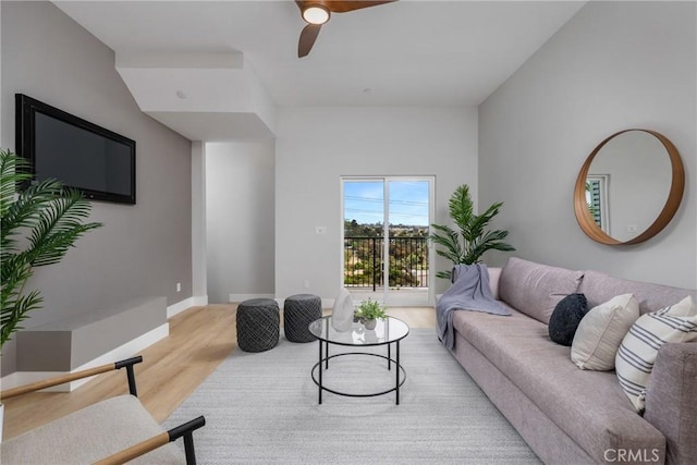 living room featuring ceiling fan and light wood-type flooring