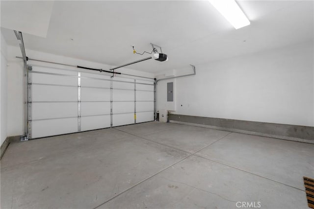 garage featuring a garage door opener and electric panel