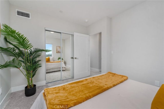 bedroom featuring light colored carpet and a closet