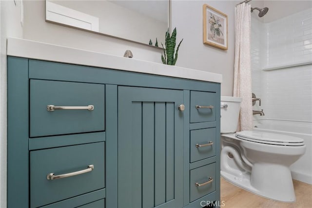 bathroom featuring hardwood / wood-style flooring, shower / bath combo with shower curtain, and toilet