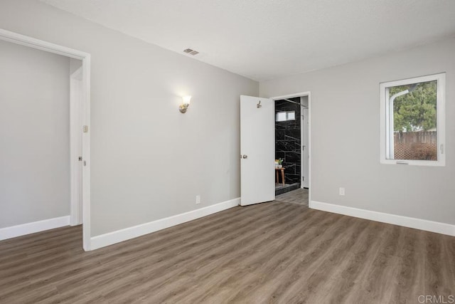 empty room featuring dark hardwood / wood-style floors