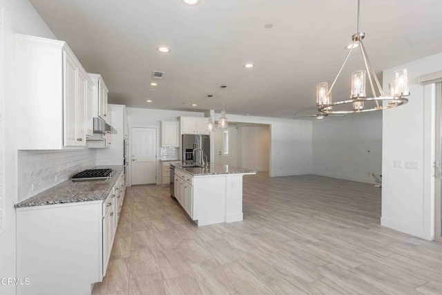 14706 Pemberley Passage Ave, Bakersfield, CA 93311 - kitchen featuring pendant lighting, white cabinetry, dark stone countertops, a kitchen island with sink, and stainless steel appliances