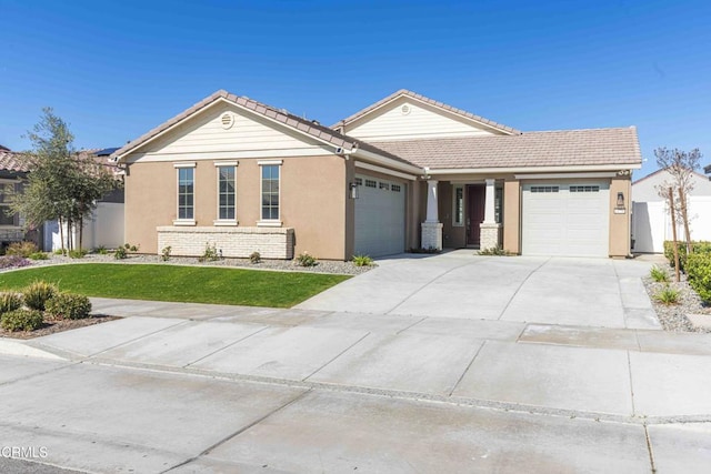 ranch-style house featuring a garage and a front lawn