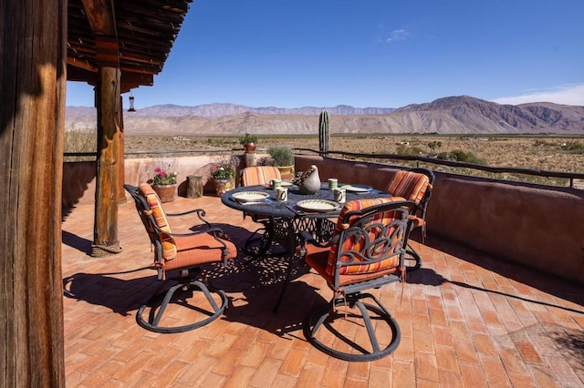 view of patio / terrace with a mountain view and outdoor dining area