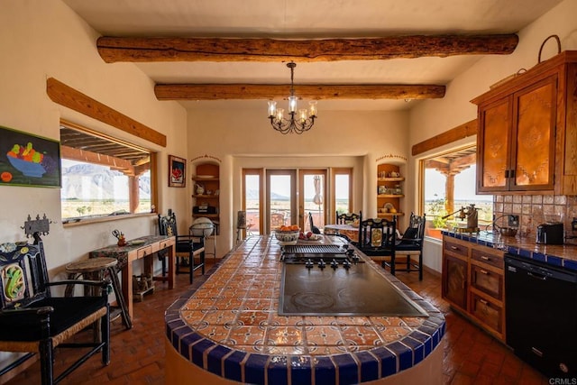 kitchen featuring brick floor, tasteful backsplash, black appliances, and an inviting chandelier