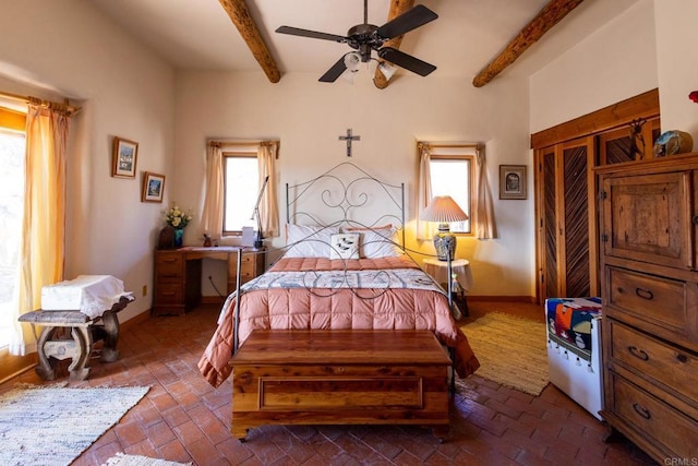 bedroom with brick floor, multiple windows, and baseboards