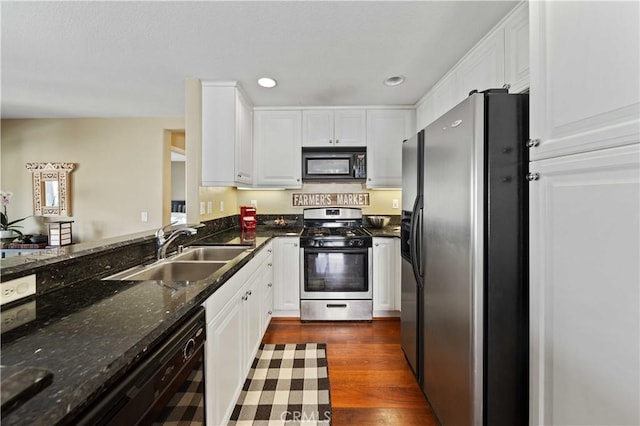 kitchen with black appliances, white cabinets, dark wood-style flooring, and a sink