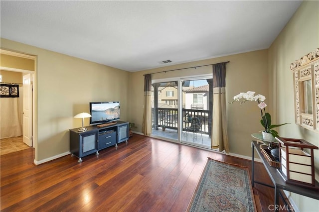 interior space featuring visible vents, baseboards, and wood finished floors