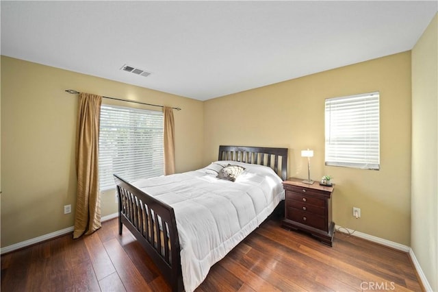 bedroom featuring visible vents, baseboards, and hardwood / wood-style flooring