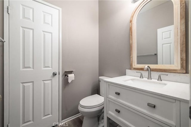 bathroom featuring vanity and toilet