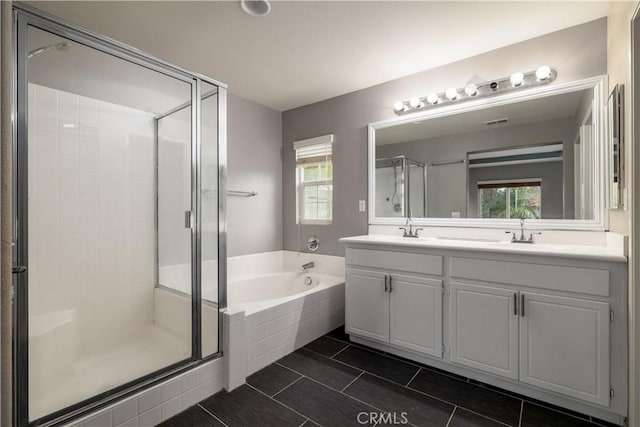 bathroom with vanity and separate shower and tub