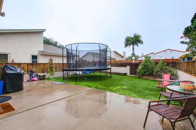 view of patio / terrace featuring a trampoline and area for grilling