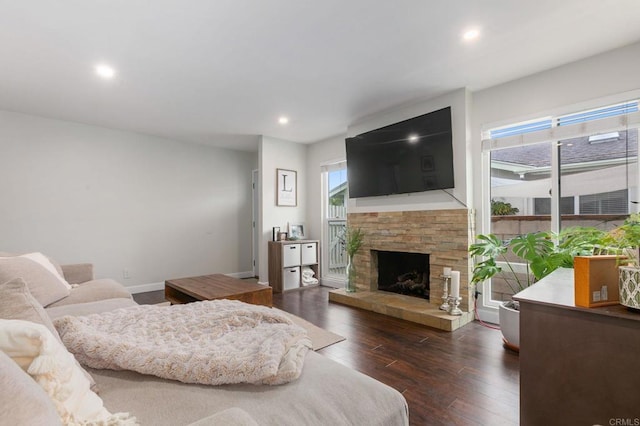 living room with dark hardwood / wood-style floors and a fireplace