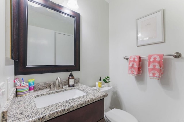 bathroom with vanity and toilet