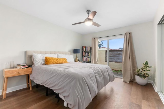 bedroom featuring access to exterior, dark wood-type flooring, and ceiling fan