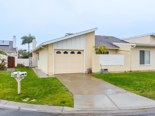 ranch-style home with a garage and a front lawn