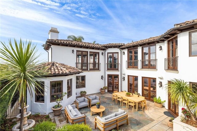 212 John St, Manhattan Beach, CA 90266 - rear view of property featuring a patio area, a chimney, an outdoor living space, a balcony, and french doors