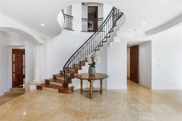 212 John St, Manhattan Beach, CA 90266 - staircase with arched walkways, decorative columns, baseboards, and recessed lighting