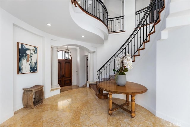 212 John St, Manhattan Beach, CA 90266 - foyer entrance with a towering ceiling, baseboards, recessed lighting, decorative columns, and arched walkways
