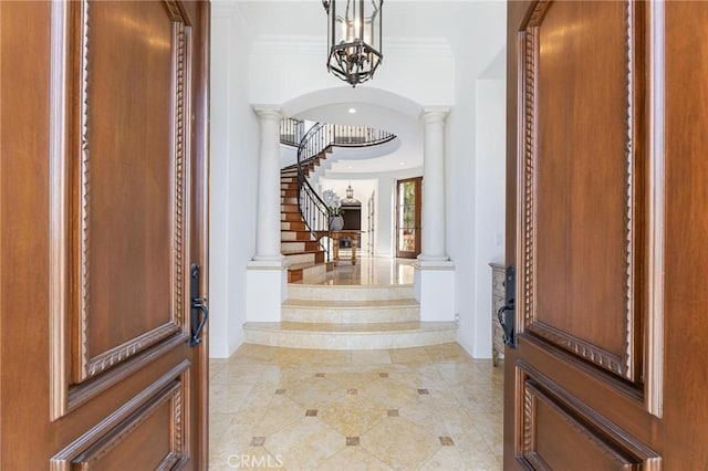 212 John St, Manhattan Beach, CA 90266 - entryway featuring a notable chandelier, baseboards, stairway, crown molding, and arched walkways