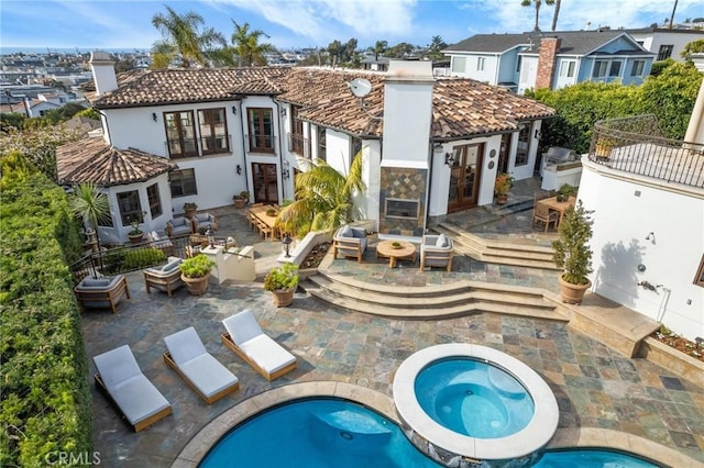 212 John St, Manhattan Beach, CA 90266 - back of property with a chimney, a patio area, an in ground hot tub, french doors, and a residential view
