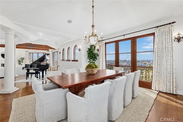212 John St, Manhattan Beach, CA 90266 - dining space featuring ornate columns, a notable chandelier, wood finished floors, and a healthy amount of sunlight
