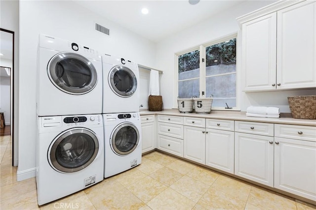 212 John St, Manhattan Beach, CA 90266 - laundry area featuring cabinet space, visible vents, washing machine and dryer, and stacked washer / dryer