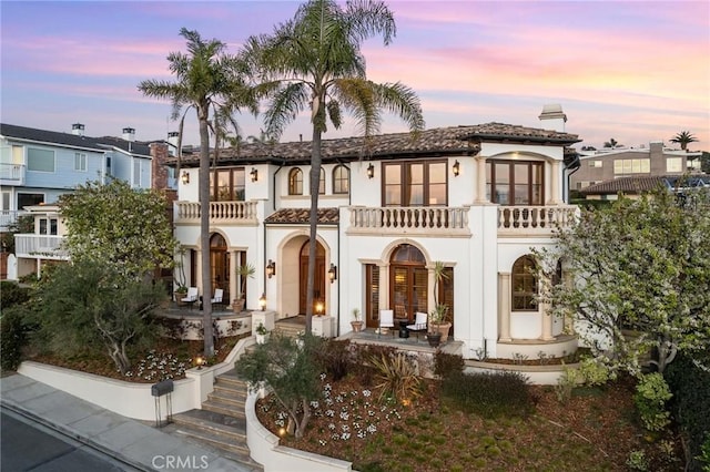 212 John St, Manhattan Beach, CA 90266 - view of front of property with stucco siding, a tile roof, a balcony, french doors, and a chimney