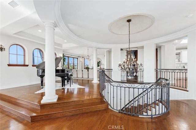 212 John St, Manhattan Beach, CA 90266 - stairway with baseboards, an inviting chandelier, crown molding, decorative columns, and wood finished floors