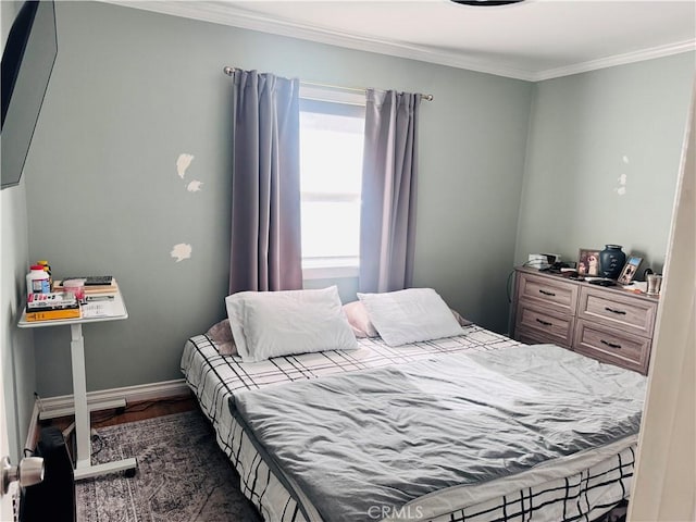 bedroom featuring ornamental molding and dark hardwood / wood-style floors