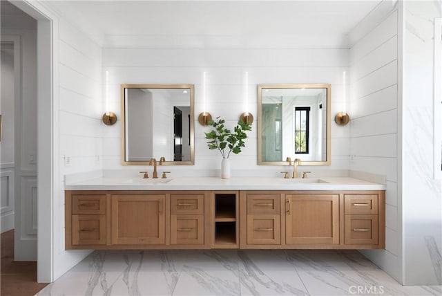 bathroom with marble finish floor, a sink, and double vanity