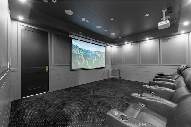 carpeted cinema featuring recessed lighting, wood ceiling, and a decorative wall