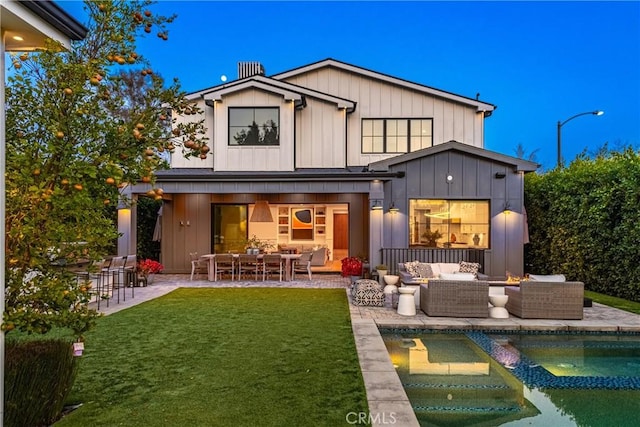 back of property with an outdoor pool, a lawn, a patio, an outdoor hangout area, and board and batten siding