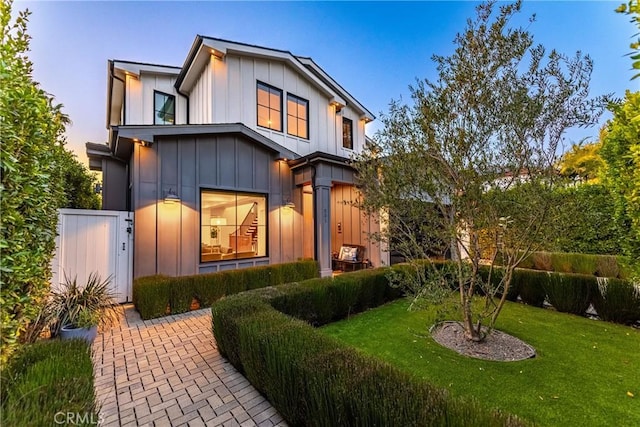 view of front of home with board and batten siding and a lawn